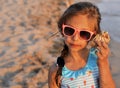 Cute little girl plays on the beach. Royalty Free Stock Photo