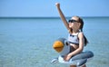 Cute little girl plays on the beach. Royalty Free Stock Photo