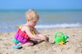 Cute little girl plays on the beach Royalty Free Stock Photo