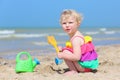 Cute little girl plays on the beach Royalty Free Stock Photo