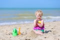 Cute little girl plays on the beach Royalty Free Stock Photo