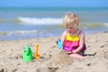 Cute little girl plays on the beach Royalty Free Stock Photo