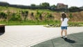 cute little girl plays outdoors on the summer , and walks around the park, happy childhood