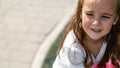 cute little girl plays outdoors on the summer , and walks around the park, happy childhood