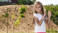 cute little girl plays outdoors on the summer , and walks around the park, happy childhood