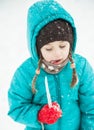 Cute little girl plays in snow.
