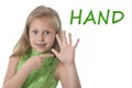 Cute little girl pointing her hand in body parts learning English words at school