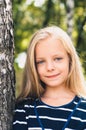 Cute Little girl portrait near tree birch.