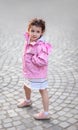 Cute Little Girl Posing on a Cobblestone Pavement