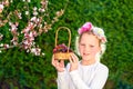 Cute little girl posing with fresh fruit in the sunny garden. Little girl with basket of grapes. Royalty Free Stock Photo