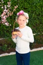 Cute little girl posing with fresh fruit in the sunny garden. Little girl with basket of grapes. Royalty Free Stock Photo