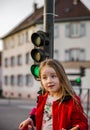 Cute little girl posing with small traffic light
