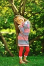 Cute little girl posing in a summer green park - portrait Royalty Free Stock Photo