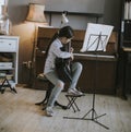 Cute little girl practicing on a acoustic guitar at home Royalty Free Stock Photo