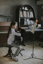 Cute little girl practicing on a acoustic guitar at home Royalty Free Stock Photo