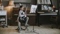 Cute little girl practicing on a acoustic guitar at home Royalty Free Stock Photo