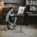 Cute little girl practicing on a acoustic guitar at home Royalty Free Stock Photo