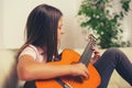 Cute little girl practicing her guitar lessons