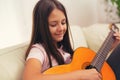 Cute little girl practicing her guitar lessons Royalty Free Stock Photo
