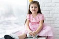 Cute little girl in a princess costume. Pretty child preparing for a costume party. Beautiful queen in gold crown. Royalty Free Stock Photo