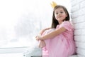 Cute little girl in a princess costume. Pretty child preparing for a costume party. Beautiful queen in gold crown. Royalty Free Stock Photo