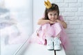 Cute little girl in a princess costume. Pretty child preparing for a costume party. Beautiful queen in gold crown. Royalty Free Stock Photo