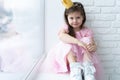 Cute little girl in a princess costume. Pretty child preparing for a costume party. Beautiful queen in gold crown. Royalty Free Stock Photo