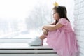 Cute little girl in a princess costume. Pretty child preparing for a costume party. Beautiful queen in gold crown. Royalty Free Stock Photo