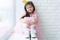 Cute little girl in a princess costume. Pretty child preparing for a costume party. Beautiful queen in gold crown. Royalty Free Stock Photo