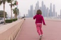 Cute little girl on the promenade by the sea Royalty Free Stock Photo