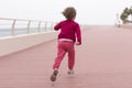 Cute little girl on the promenade by the sea Royalty Free Stock Photo