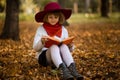 Cute little girl read interesting book in autumn Royalty Free Stock Photo