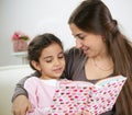 Cute little girl reading book with mother Royalty Free Stock Photo