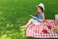 Cute little girl reading book outdoors Royalty Free Stock Photo