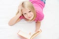 Cute little girl is reading book