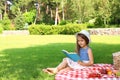 Cute little girl reading book . Summertime rest Royalty Free Stock Photo