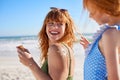 Little girl applying sunscreen lotion on mother's shoulder Royalty Free Stock Photo