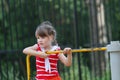 Cute little girl in red whirls on roundabout