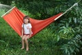 Cute little girl relaxing in hammock on summer day Royalty Free Stock Photo