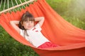 Cute little girl relaxing in hammock on summer day Royalty Free Stock Photo