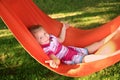 Cute little girl relaxing in hammock on sunny day outdoors Royalty Free Stock Photo