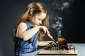 Cute little girl repair electronics by cooper-bit Royalty Free Stock Photo