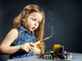 Cute little girl repair electronics by cooper-bit Royalty Free Stock Photo