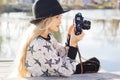 Cute little girl is resting near lake with camera Royalty Free Stock Photo