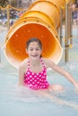 Cute little girl riding down a water slide at a water park Royalty Free Stock Photo