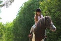 Cute little girl riding pony in park Royalty Free Stock Photo