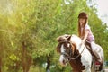 Cute little girl riding pony in park Royalty Free Stock Photo