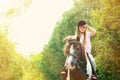 Cute little girl riding pony in park Royalty Free Stock Photo