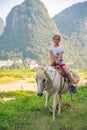 Cute little girl riding on a pony in Yangshuo Royalty Free Stock Photo