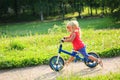 Cute little girl riding runbike in summer Royalty Free Stock Photo